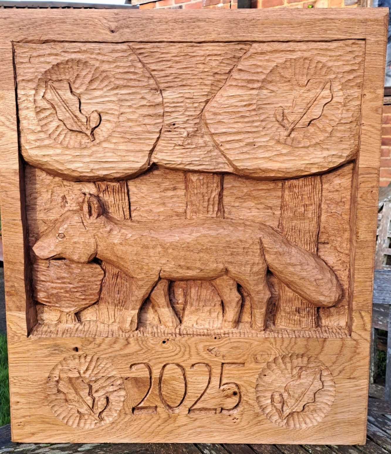 Relief panel of a fox among trees, dated 2025