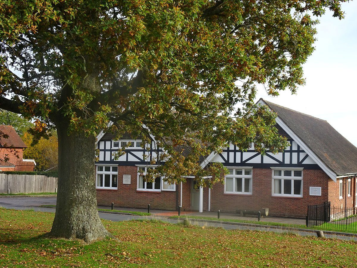 Frant Memorial Hall on the village green, beneath an oak tree in autumn