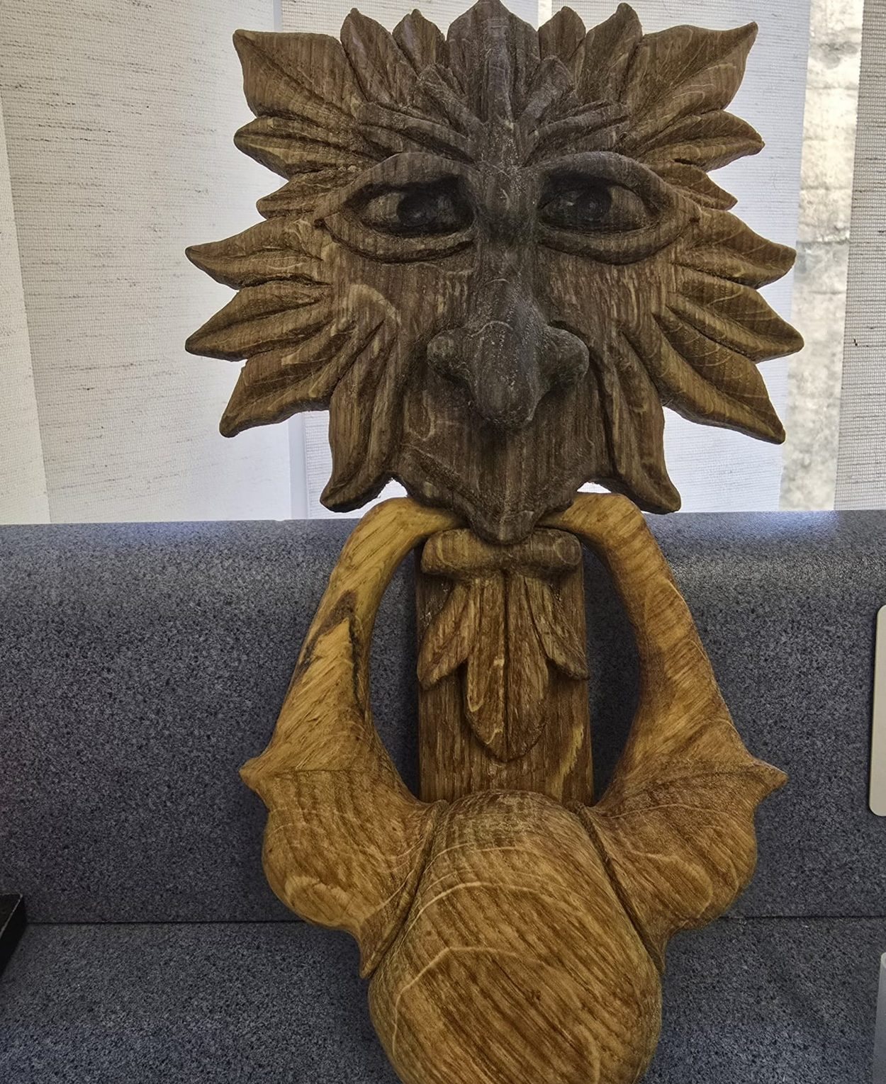 Green man door knocker with leaf hair and ring